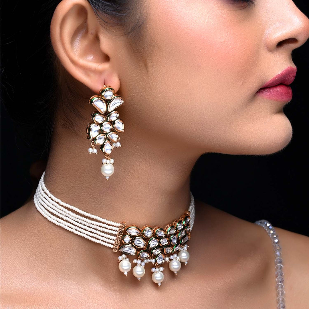 Elegant Kundan choker featuring white pearls and stunning pearl drop earrings