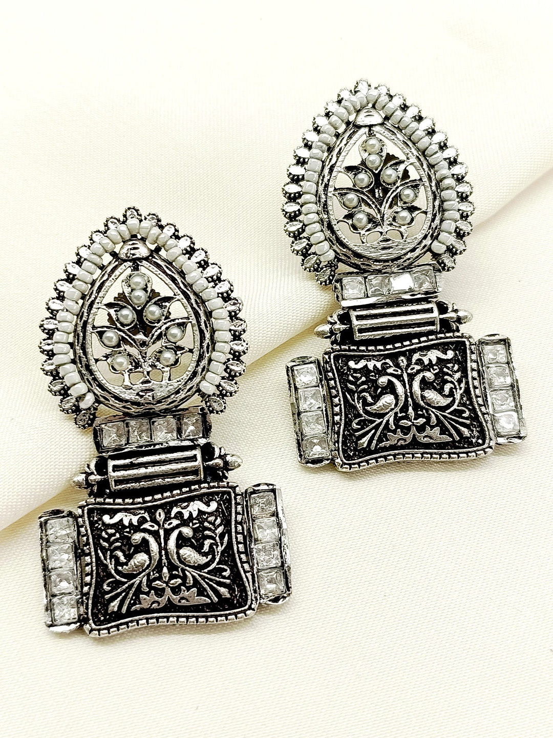 Jinisha White Boutique Earrings crafted with silver plated brass metal, adorned with delicate Kundan stone, perfect for any occasion