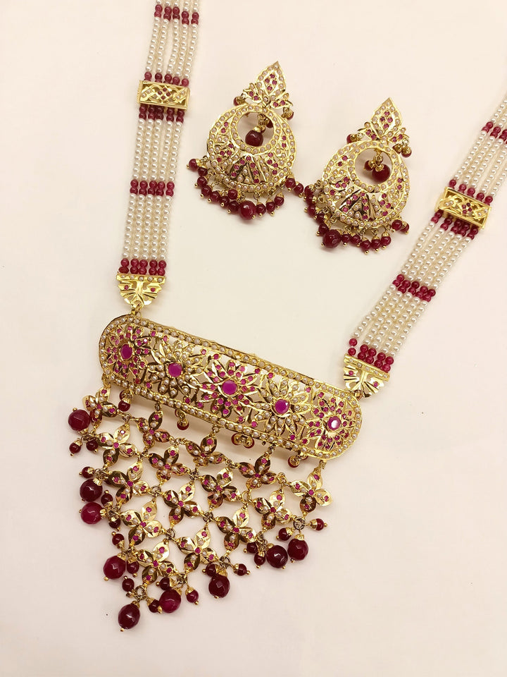  Exquisite gold plated necklace set with shimmering ruby stones and intricate design