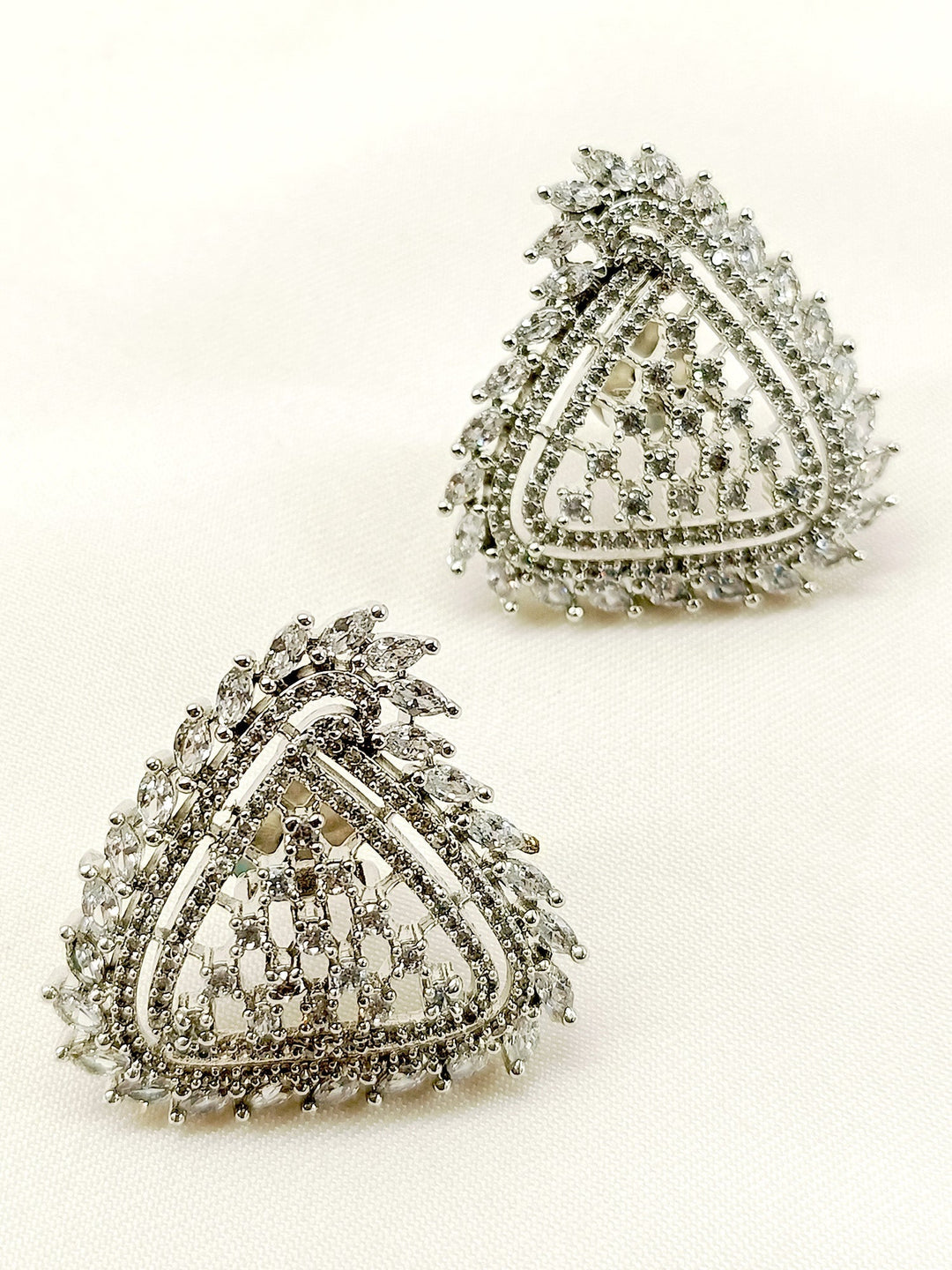 Close-up of silver plated brass metal stud earrings with delicate American diamonds 