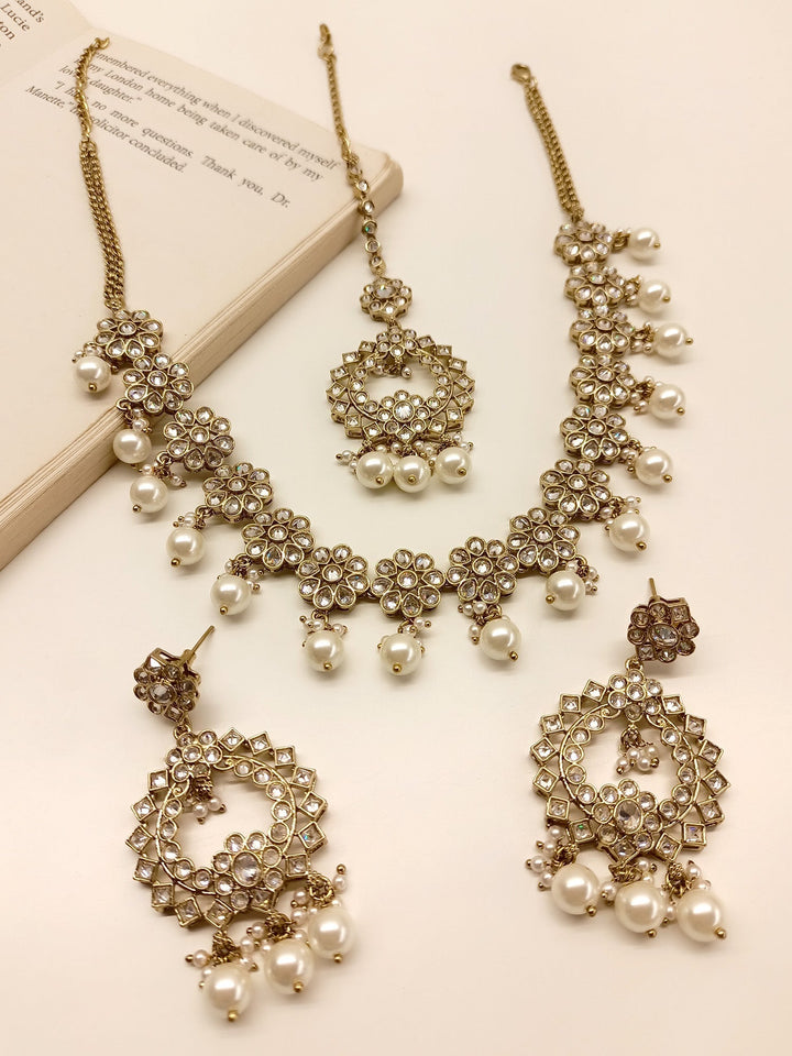 Anokhi White Polki Necklace Set with intricate floral design and sparkling gemstones