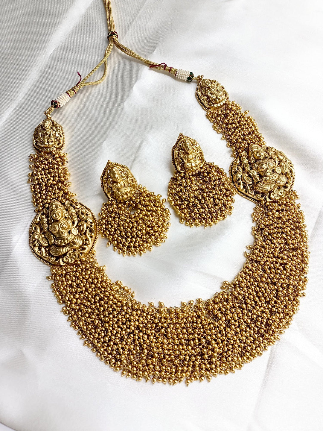 Exquisite gold and pearl long necklace with intricate temple design
