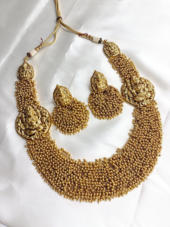 Exquisite gold and pearl long necklace with intricate temple design