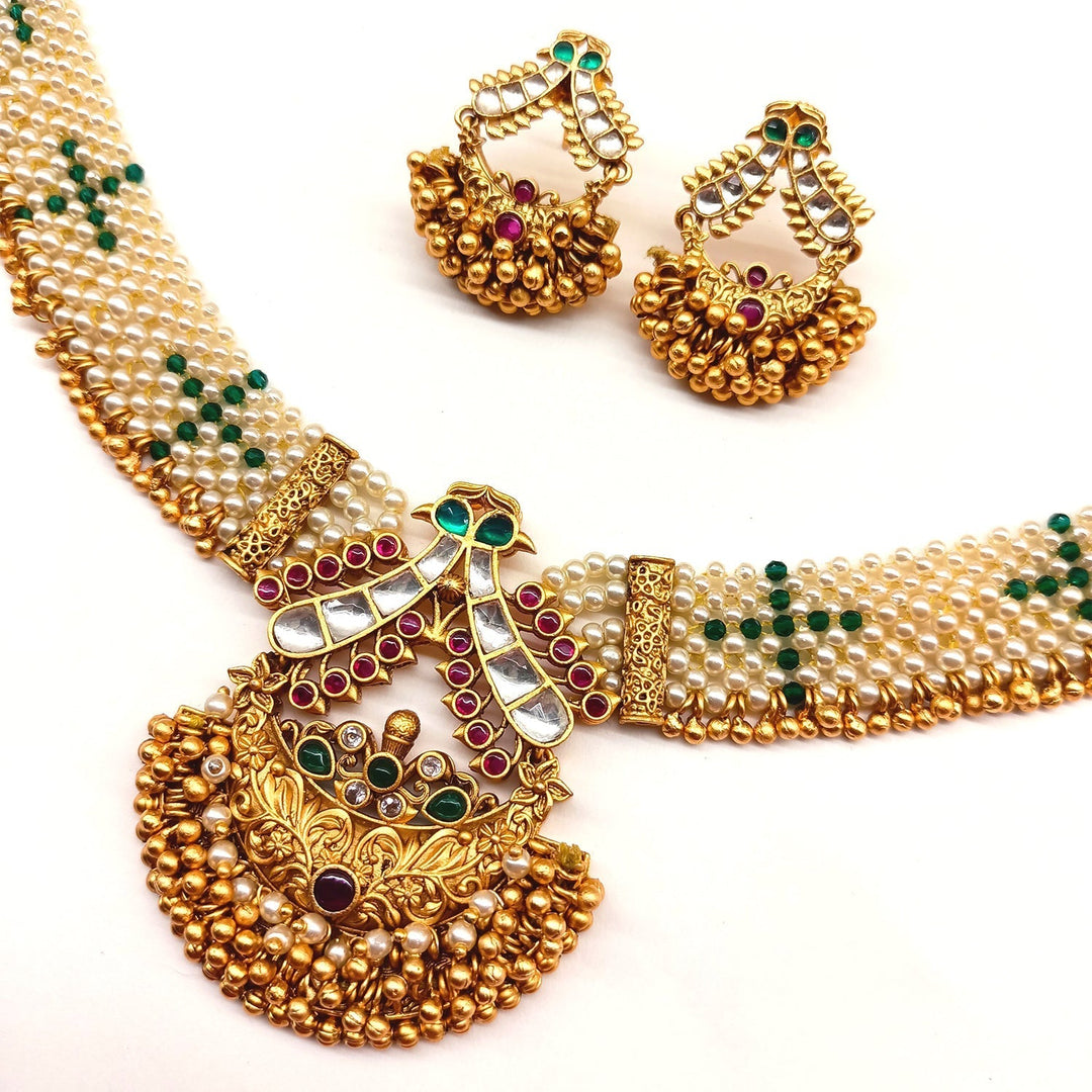 Traditional real look alike golden texture and pearl work kundan stone necklace and pretty Indian design earrings in the Adrika Rose Pink & Green Stone Temple Work Gold Plated Antique Set