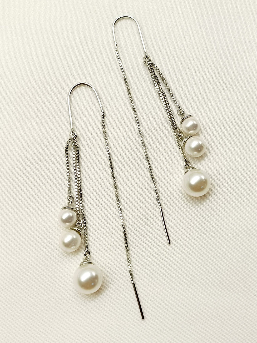Rabhya White Sui Dhaga Pearl Earrings crafted from silver plated brass metal with stunning pearl, exuding elegance and sophistication, perfect for any occasion