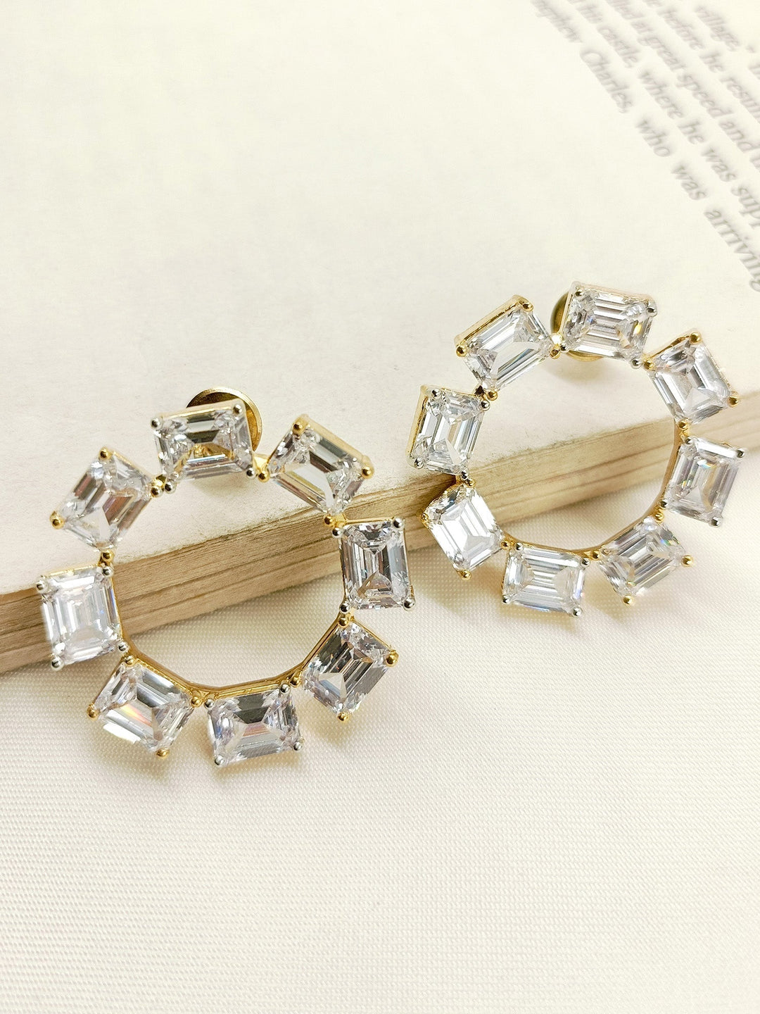 Close-up of elegant Priyasha White American Diamond Tops with gold plated brass metal and genuine American diamonds, sparkling in the light 