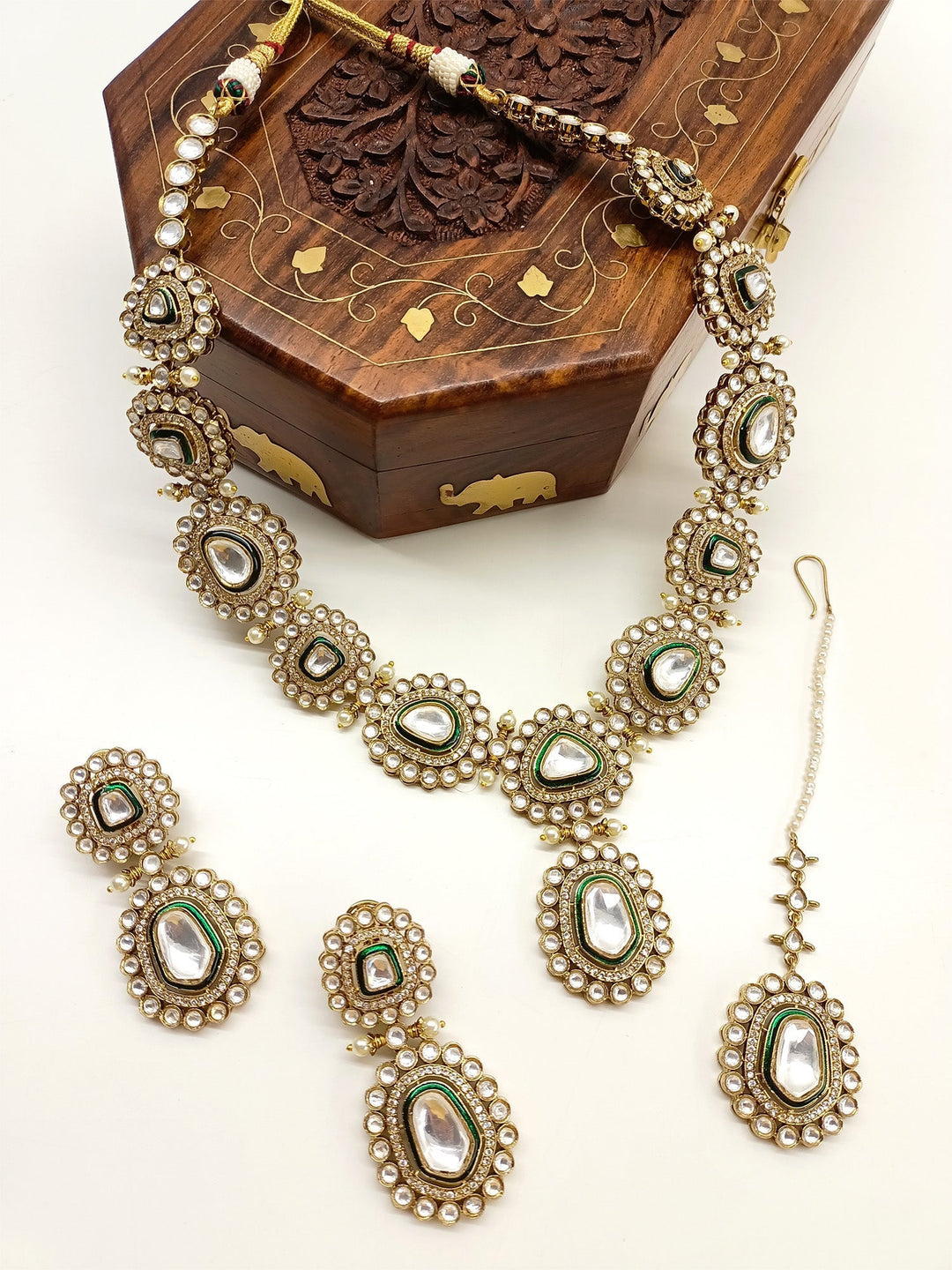 Sunidhi Green Polki Necklace Set, crafted from high quality antique gold plated brass metal and adorned with beautiful pearls with American diamond setting, perfect for an unforgettable bridal experience