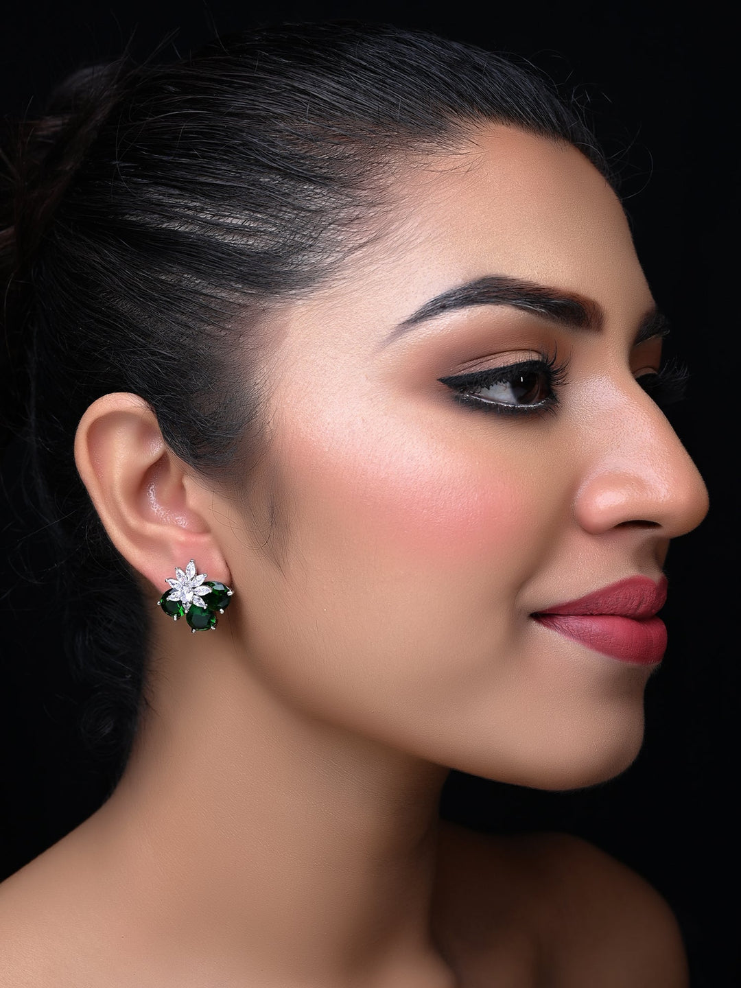 Richa American Diamond Green Emerald Tops with the following description: Trendy American Diamond Tops (studs) With Semi Precious Green Emerald (aqua) Stone Brass Metal Silver Plated

Stylish silver plated brass metal American diamond tops with aqua green emerald stud 