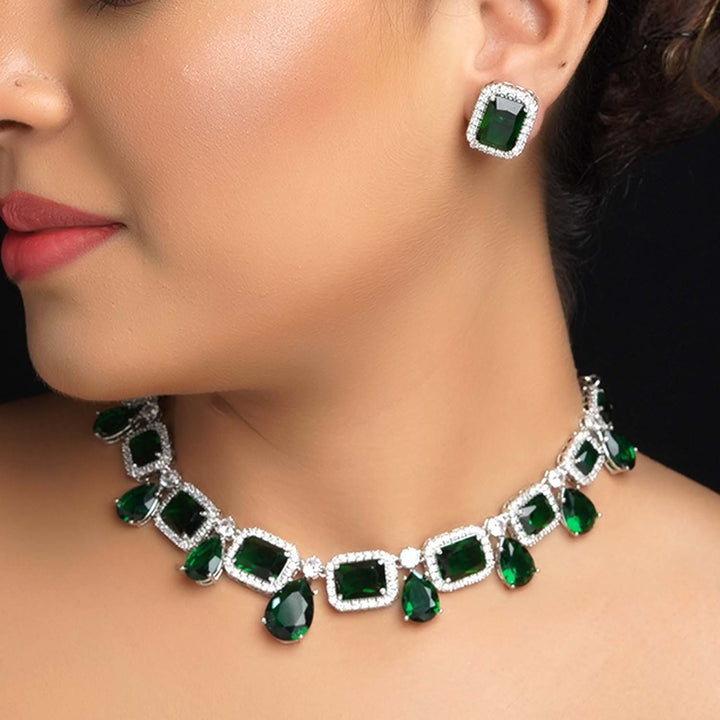  Elegant jewelry set featuring green emerald and American diamond stones 