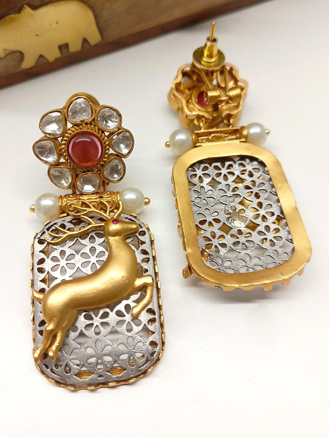 Intricate deer motifs with back-clip and pearl detailing