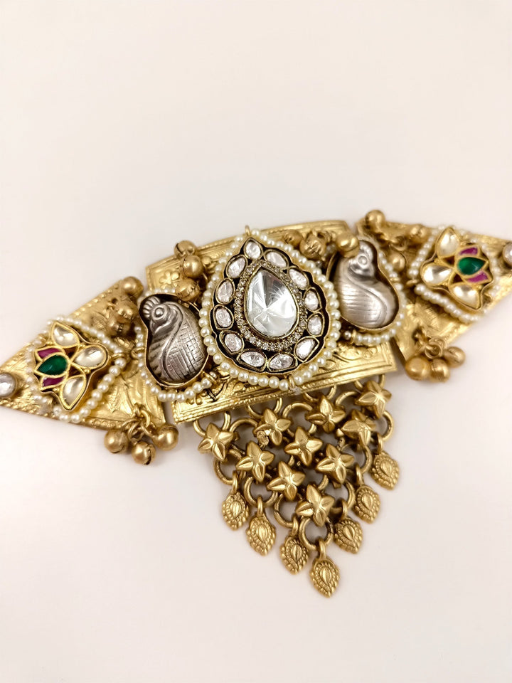 Elegant choker made of gold plated brass metal with Kundan detailing and peacock motifs