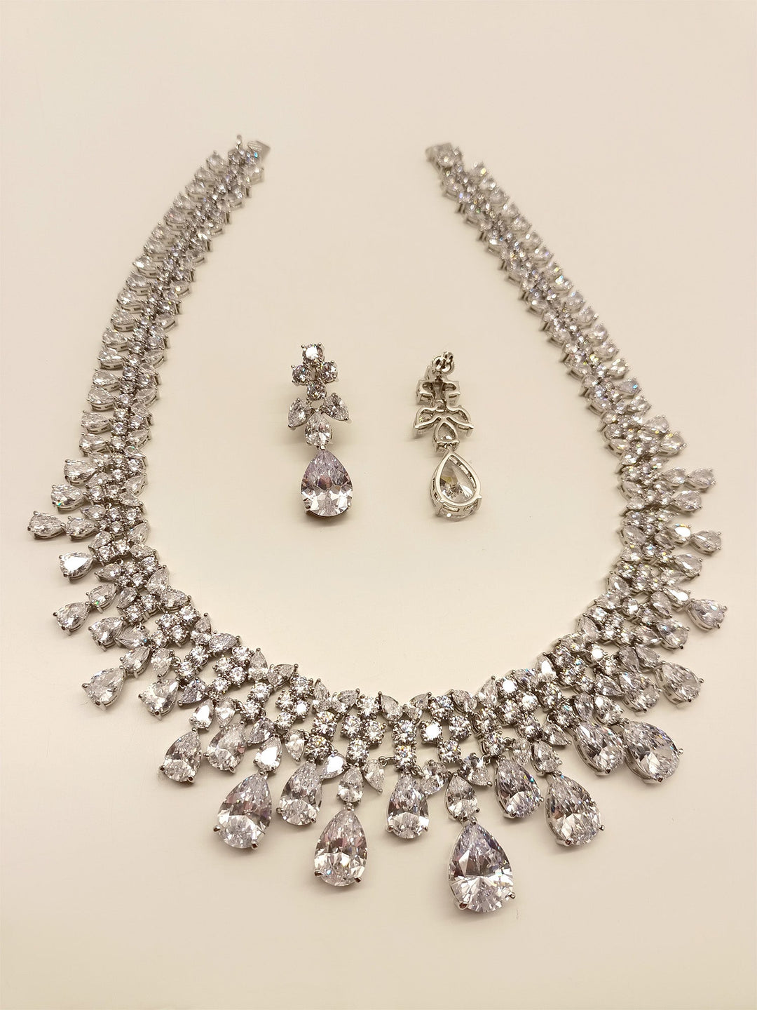Exquisite White American Diamond Necklace Set made with silver plated brass metal, emitting undeniable sparkle and brilliance, perfect for any special occasion