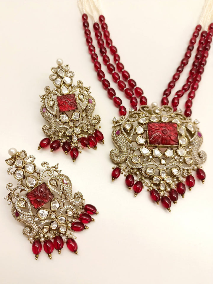  Intricately crafted Kundan Polki Necklace Set adorned with vibrant triple layered beads chain and ruby pearl hanging 