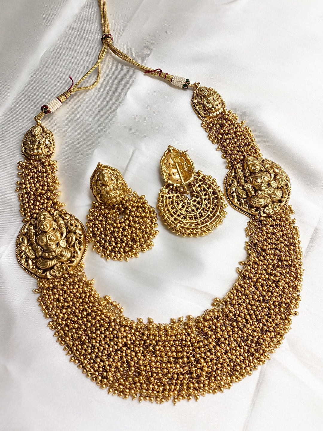 Aneeqa Long Temple Necklace Set: Gold-plated statement necklace with intricate pendant and matching earrings