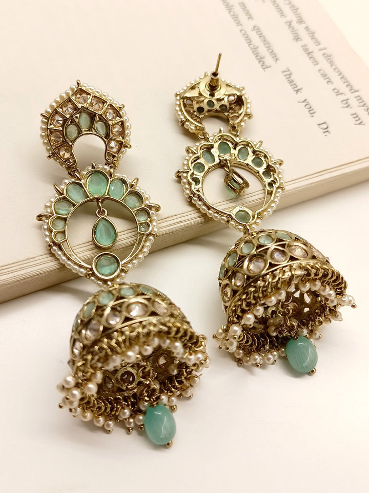 Beautiful Marlee Mint Green Polki Jhumki earrings made of antique gold plated brass metal with stunning Polki Jhumki and pearl hanging