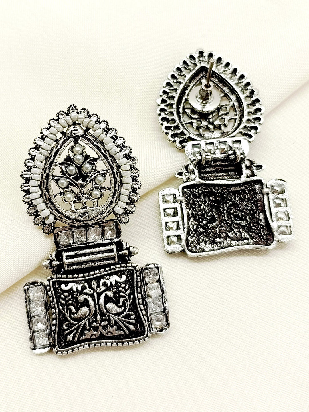 Elevate your style with these timeless Jinisha White Boutique Earrings featuring traditional craftsmanship