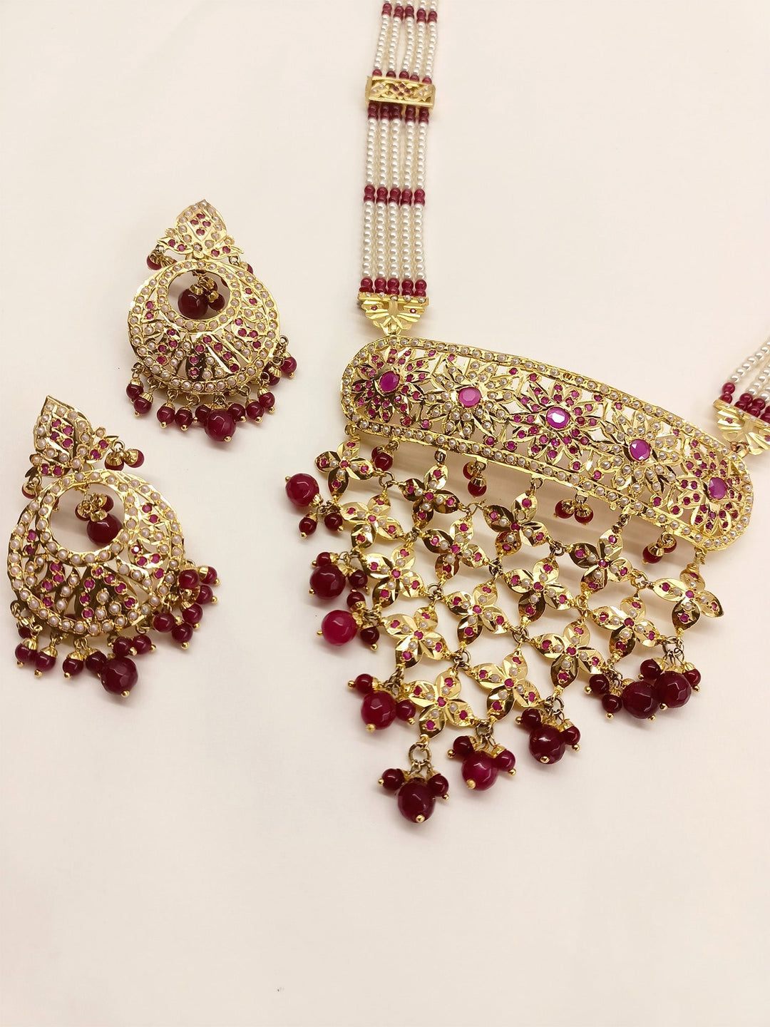  Elegant ruby jadau necklace set crafted from lustrous brass metal and beautiful rubies