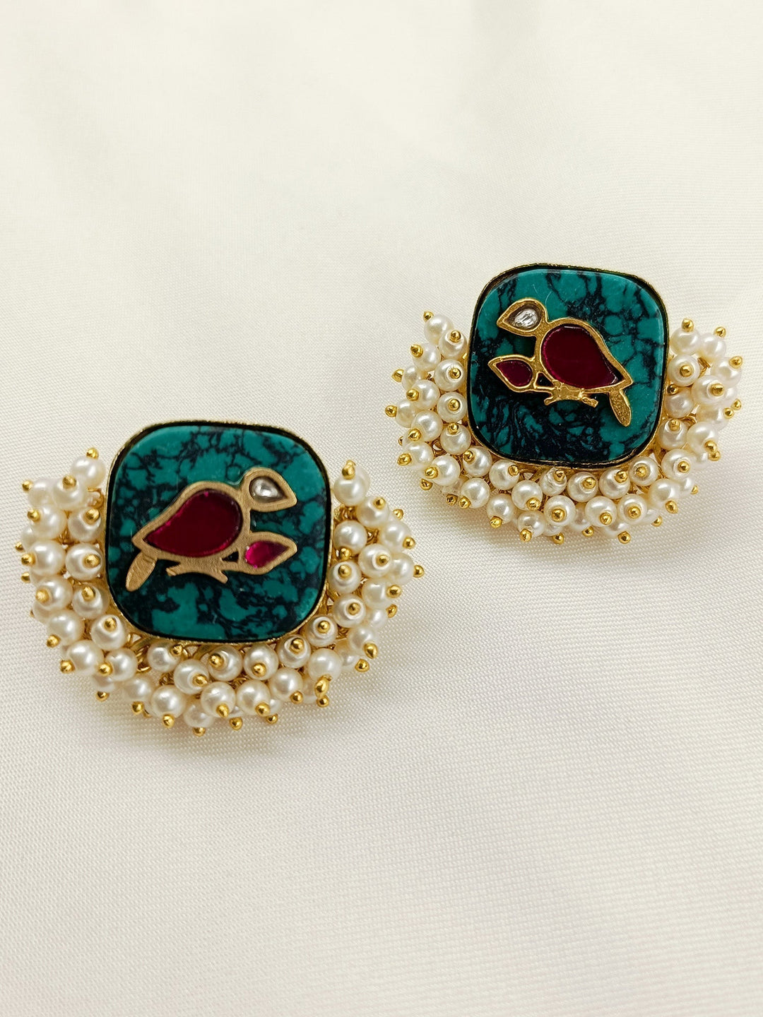 Elegant and timeless boutique top made from gold plated brass metal with delicate pearl detailing and bird motifs