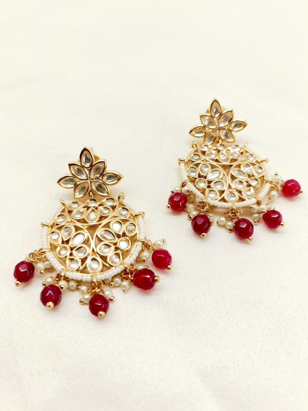 Exquisite maroon Kundan earrings with intricate gold detailing and delicate pearl drops