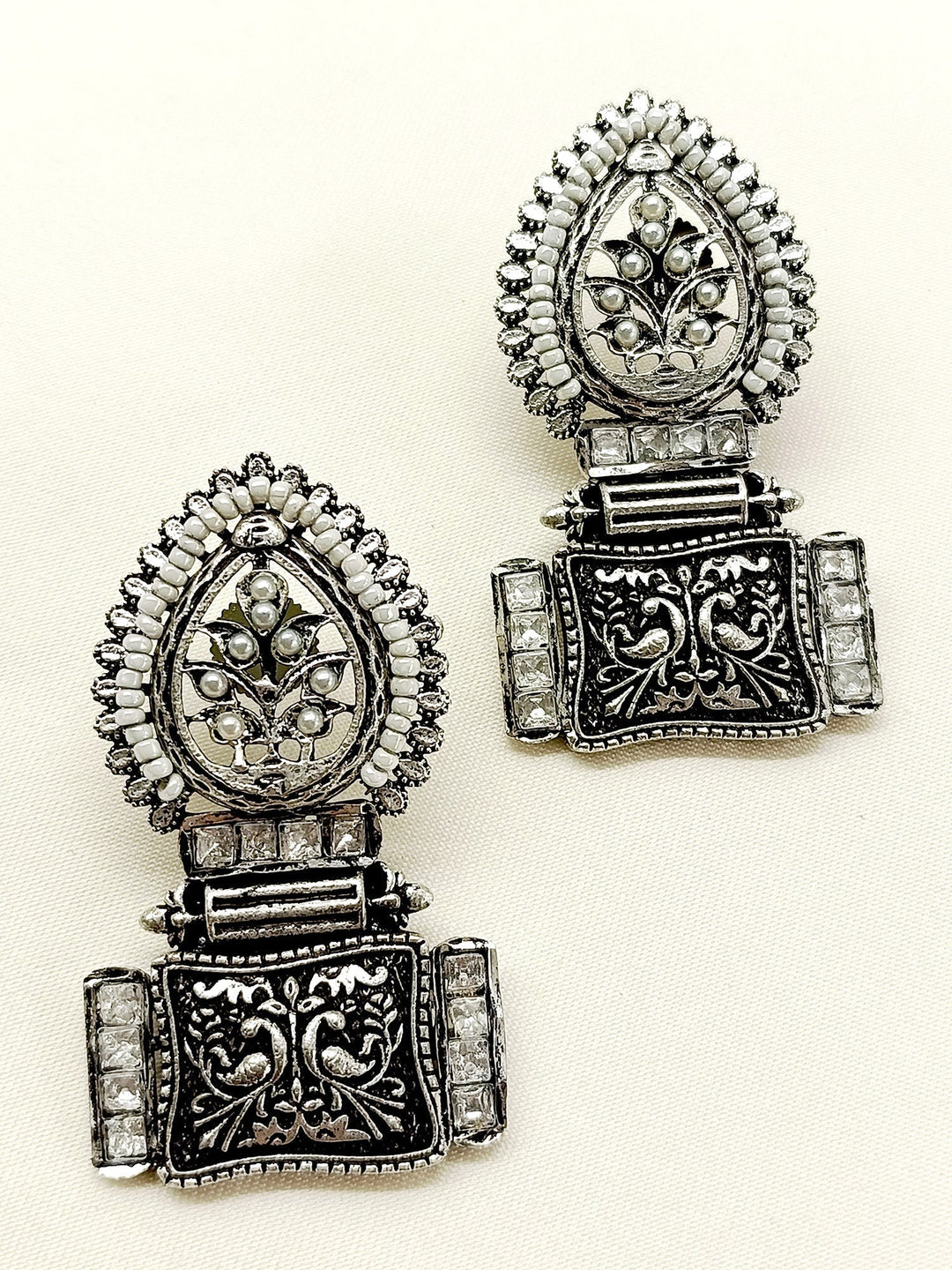 Enhance your look with the exquisite Jinisha White Boutique Earrings, a must-have for any occasion