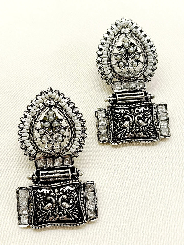 Enhance your look with the exquisite Jinisha White Boutique Earrings, a must-have for any occasion