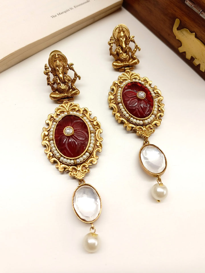 Handcrafted maroon Ganesh Ji boutique earrings with intricate detailing and delicate design