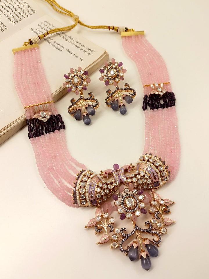  Intricately designed Pink Kundan Necklace Set with gold plated brass metal and multiple layered beads chain for a classic touch 