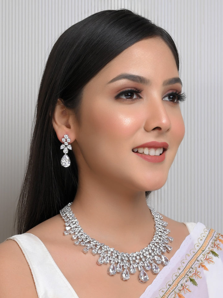 Firaki White American Diamond Necklace Set crafted with silver plated brass metal, radiating undeniable sparkle and brilliance, perfect for any special occasion