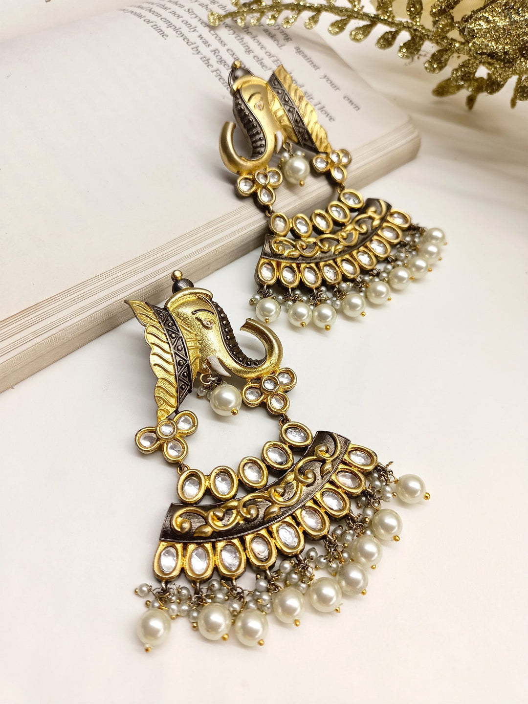 Gold elephant shaped Kundan earrings with intricate detailing and colorful gemstones