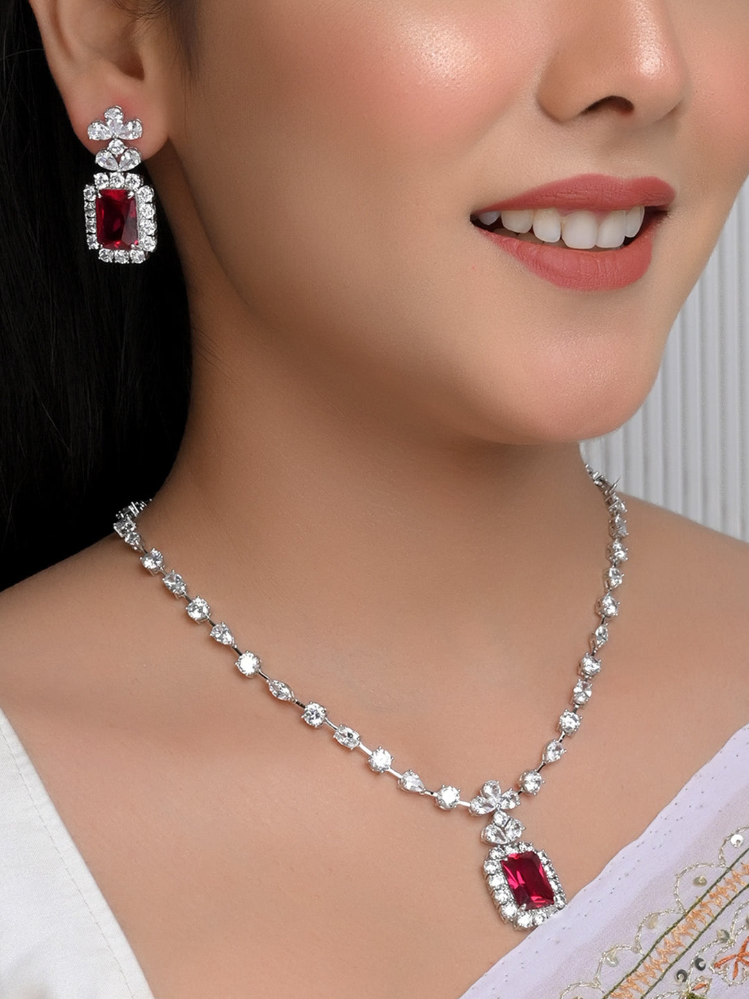 Delicately adorned with sparkling majenta and American diamond stones