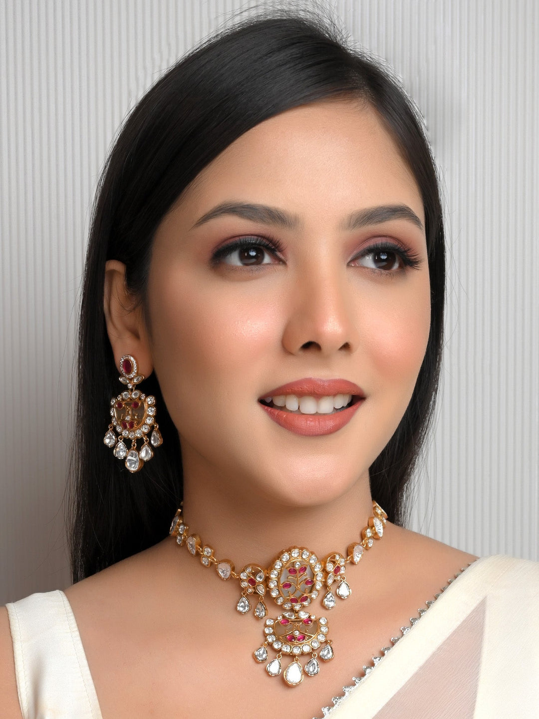 Iraye Majenta Boutique Choker Set crafted of gold plated brass metal with a polki and natural pearl for a stunning look