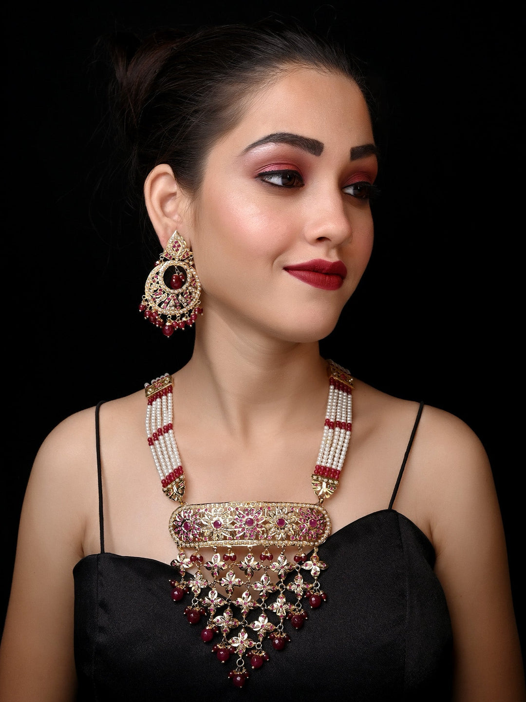 Gold plated brass metal necklace set with intricate design and ruby stones