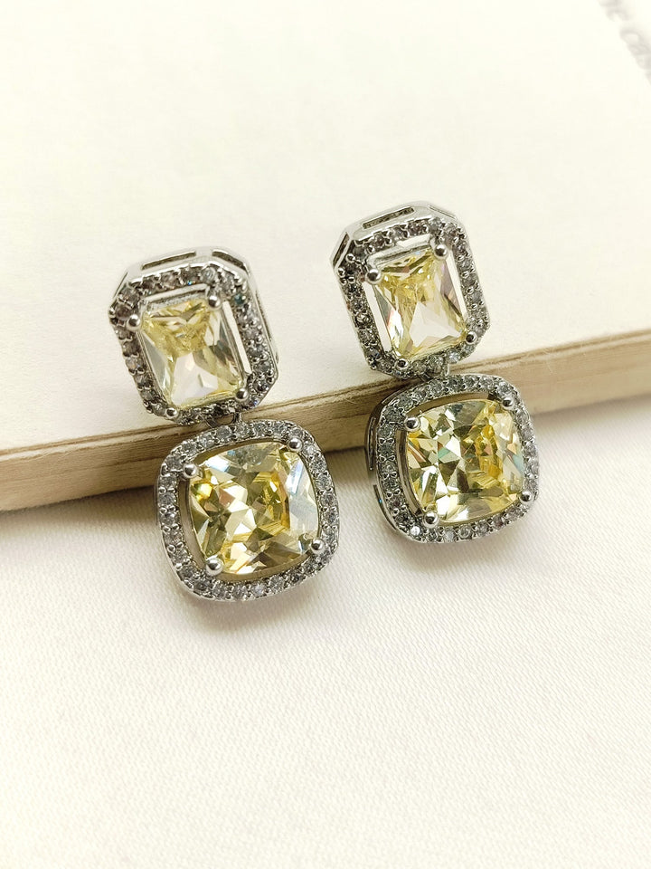 Close-up of Rituja Yellow Stone Silver Plated Diamond Earrings with beautiful American Diamond and yellow stone details