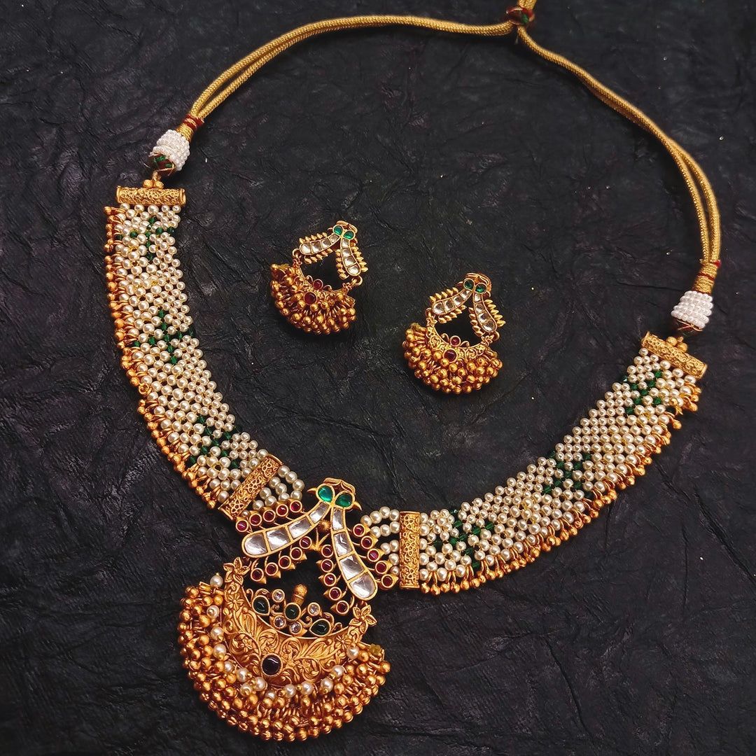 Adrika Rose Pink & Green Stone Temple Work Gold Plated Antique Set necklace featuring real look alike golden texture and pearl work kundan stone