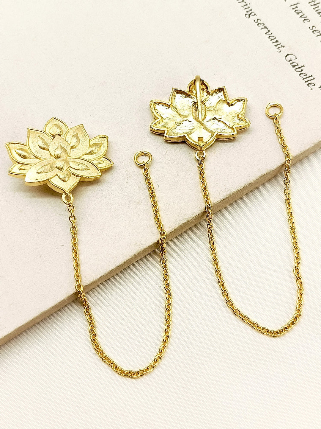  Elegant Badr Golden Boutique Earchain, crafted with traditional techniques and complete with a delicate golden chain lotus flower A must-have accessory for all occasions