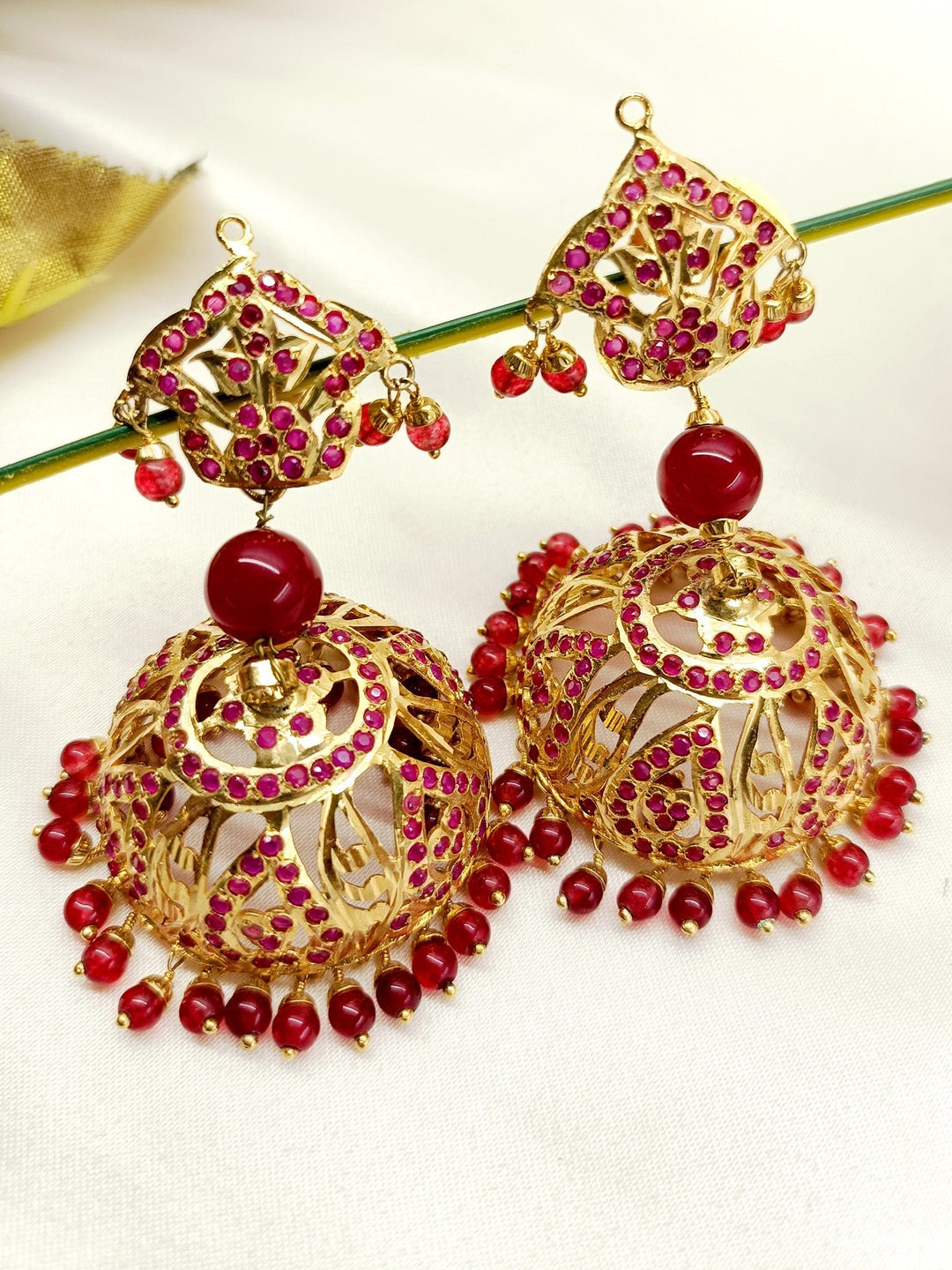 Exquisite gold plated brass metal Jhumki with stunning Ruby Jadau designs perfect for special occasions