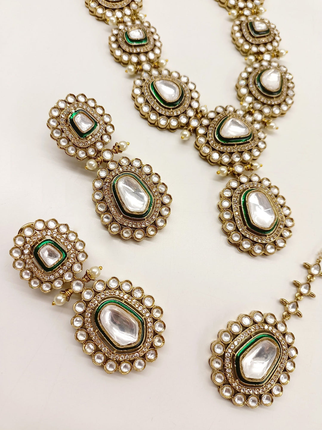  Beautiful Green Polki Necklace Set, made from high quality antique gold plated brass metal and featuring stunning pearls with American diamond setting, a timeless and traditional bridal wear accessory