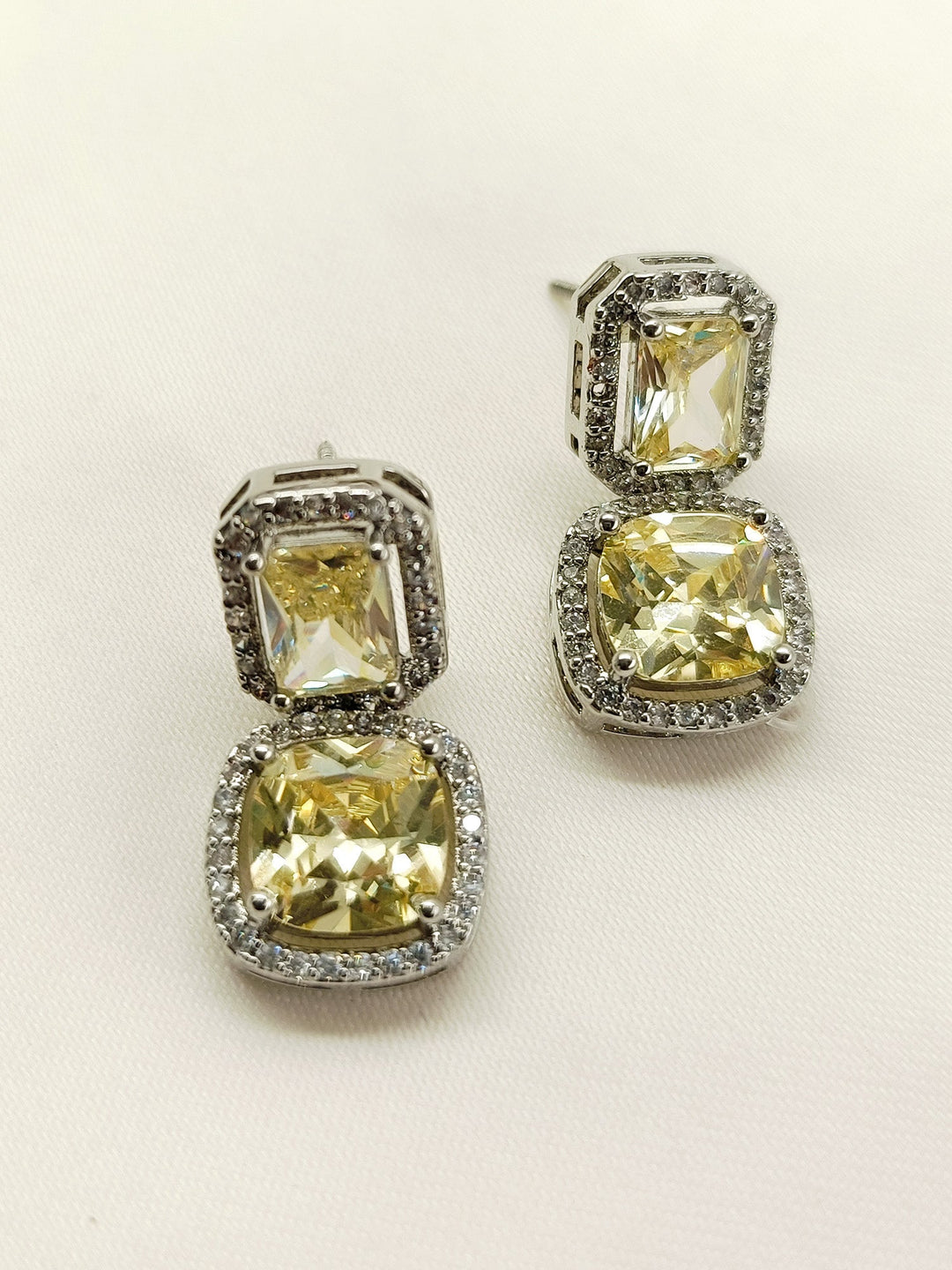  High-quality Rituja Yellow Stone Silver Plated Diamond Earrings with eye-catching American Diamond and yellow stone embellishments