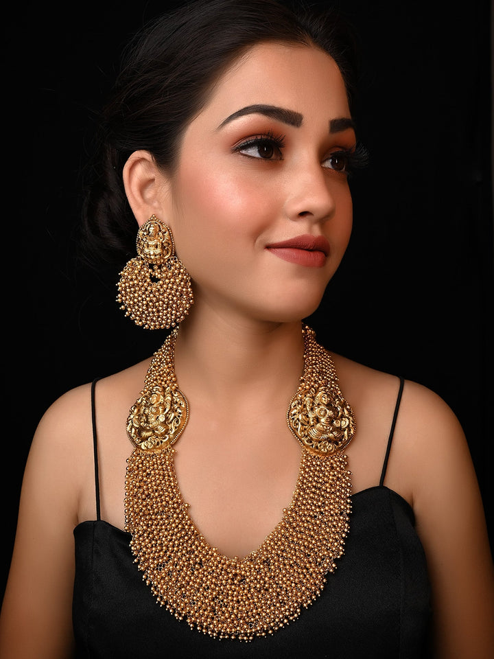 Aneeqa Long Temple Necklace Set with Intricate Gold Design and Red Gemstones