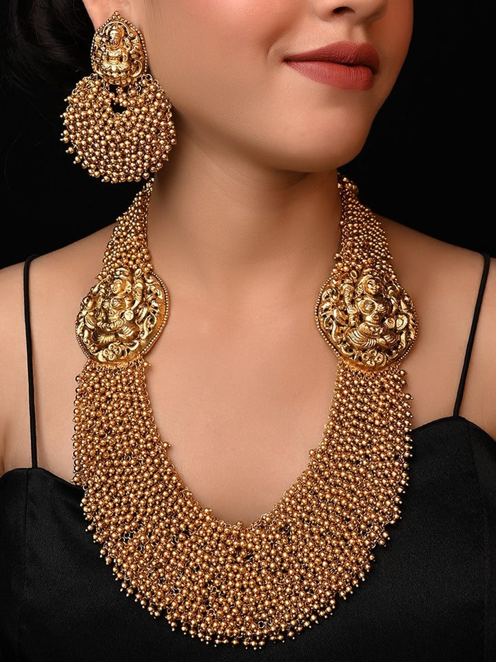 Aneeqa Long Temple Necklace Set with intricate gold detailing and colorful gemstone accents