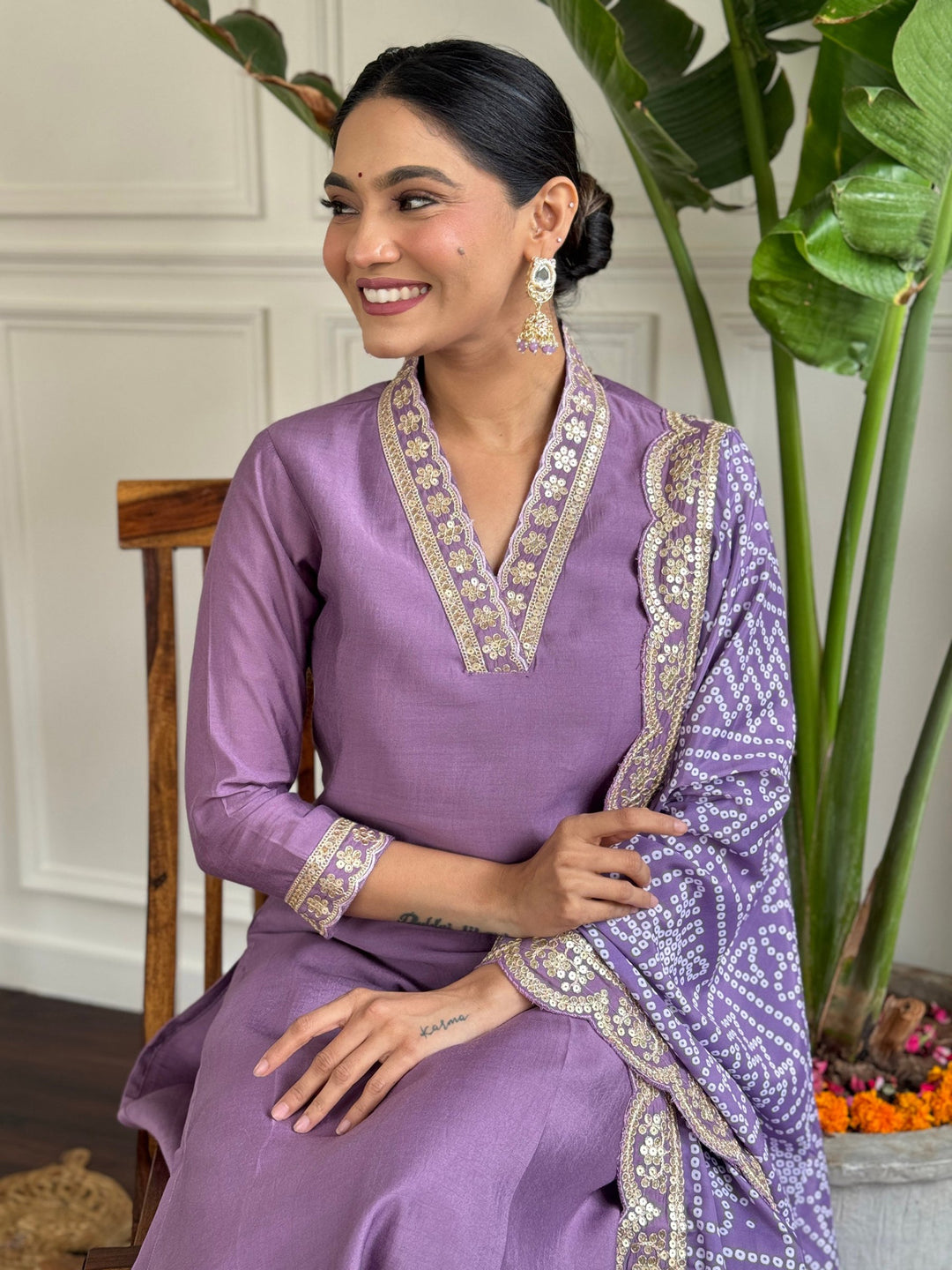 Beautiful purple straight suit with intricate thread embroidery and sequin work
