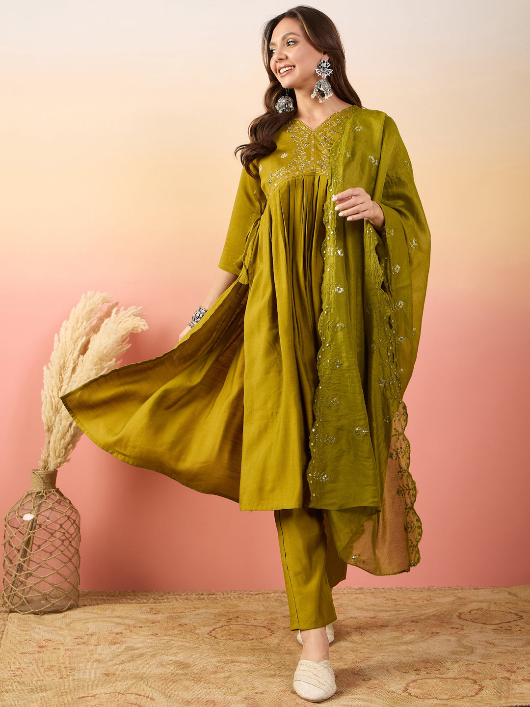 Mustard yellow silk suit adorned with intricate embroidered and sequin work 
