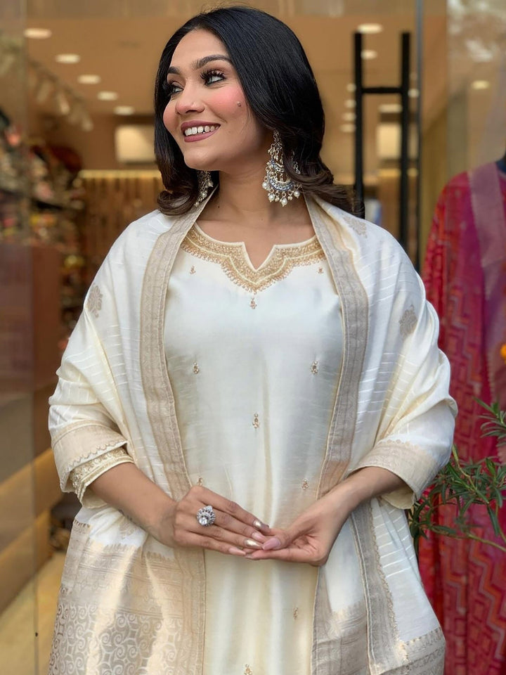 Off-white embroidered festival wear pant suit with intricate designs and patterns