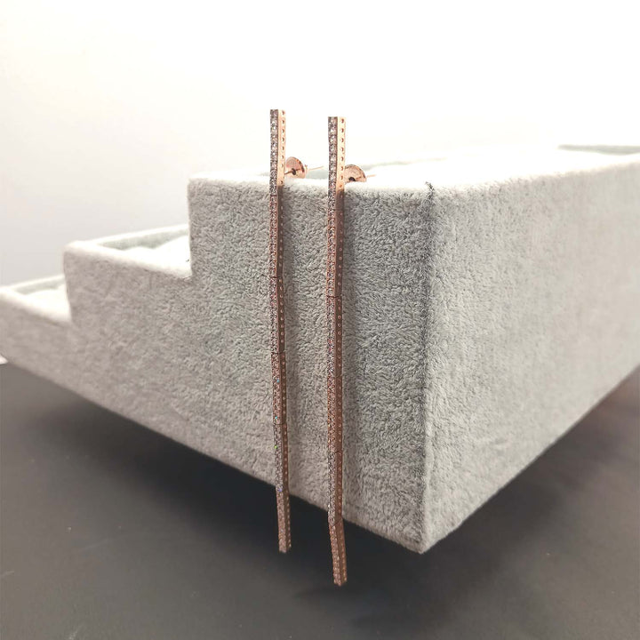  Stunning long danglers featuring rose gold plating and dazzling American diamonds