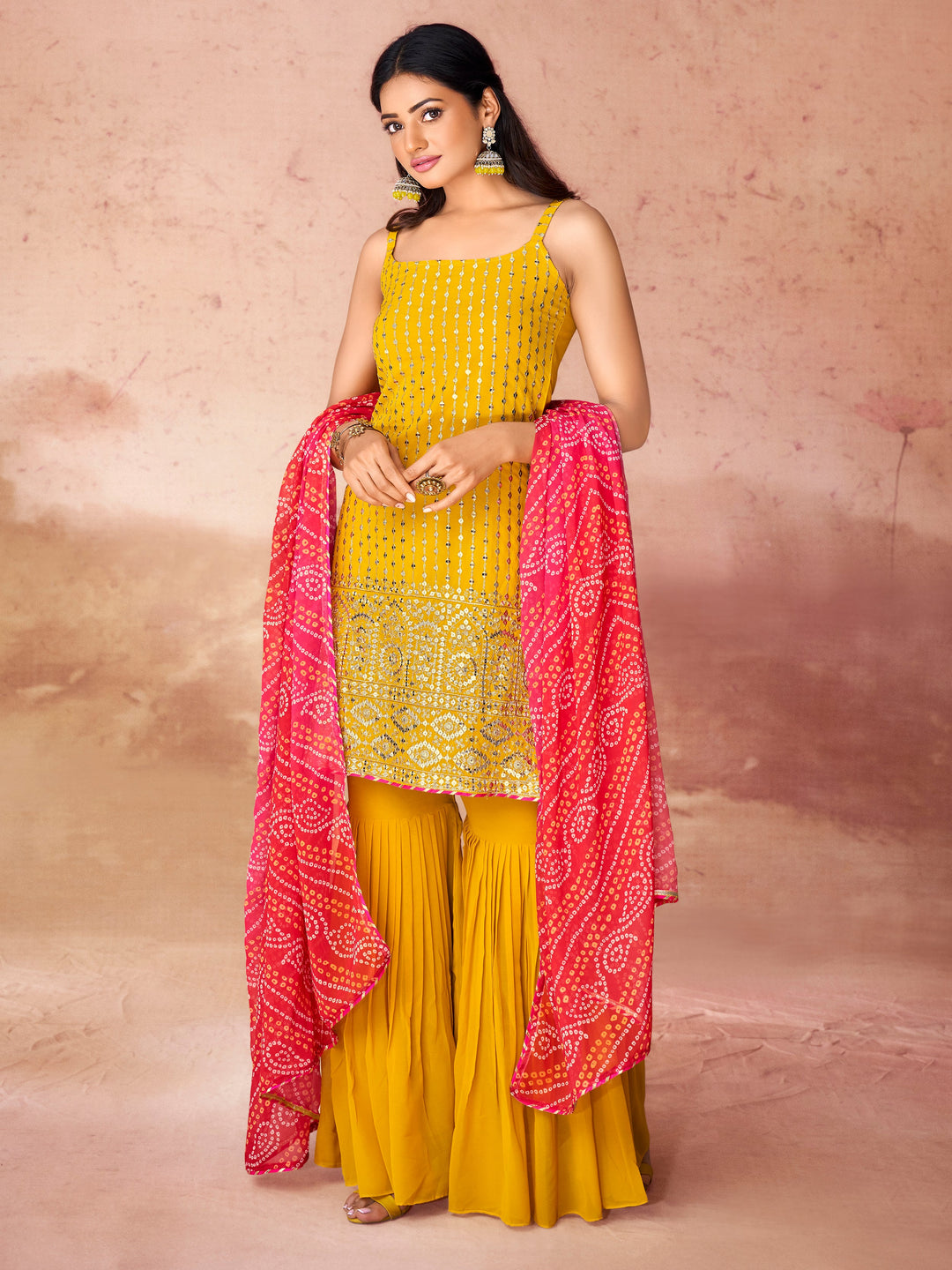 Yellow georgette suit with intricate sequin work and matching sharara