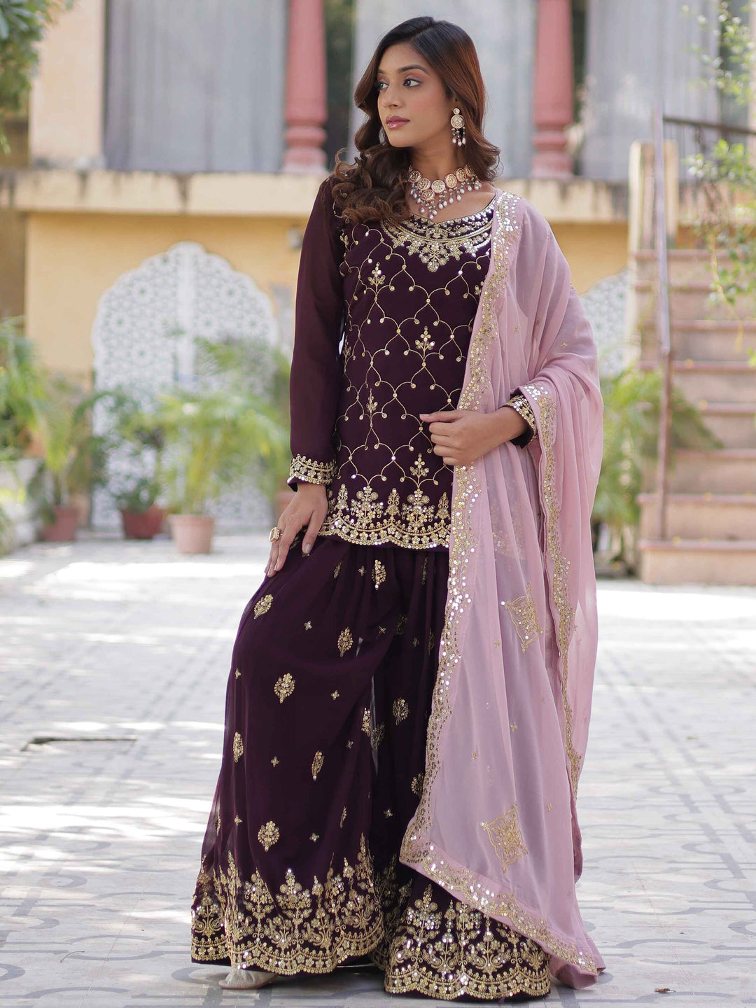 

Ravishing Wine Embroidered Georgette Eid Wear Sharara Suit with stylish pan-shaped neck and full sleeves