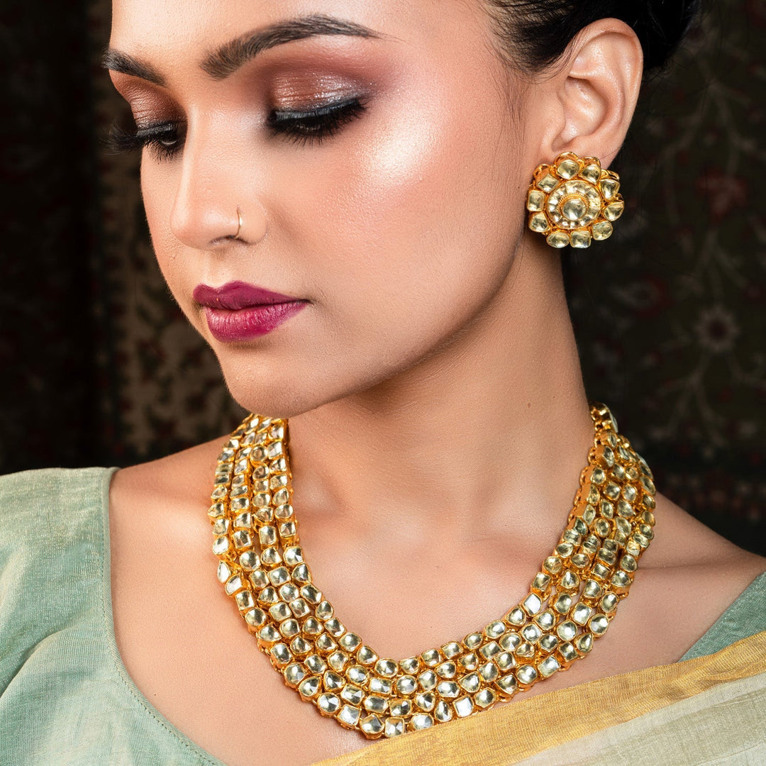 Beautifully designed three layered Aamira Golden Coloured Pachi Kundan Long Necklace Set with uneven shape Pachi Kundan pieces and round studs for a modern traditional look