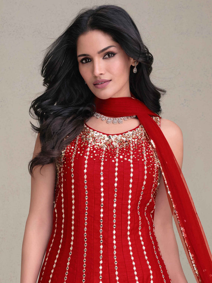 Luxurious red silk dhoti suit with embroidered top and elegant net dupatta