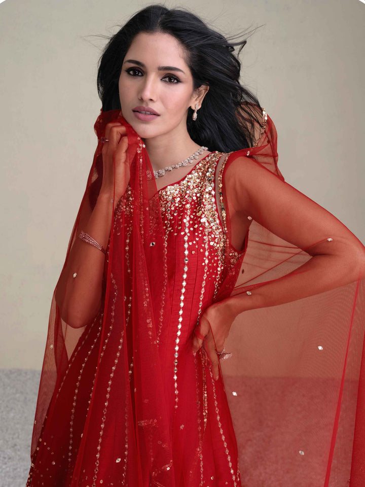 Elegant red silk dhoti suit with intricate sequin work and regal design