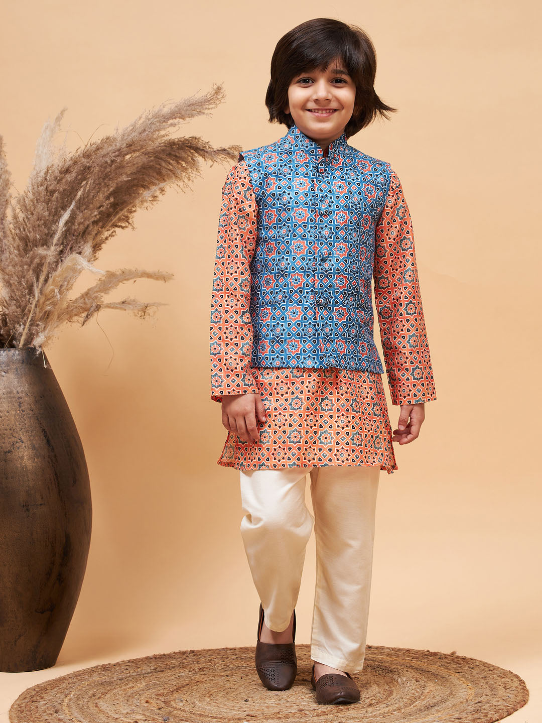 VASTRAMAY Boy's Orange Printed Kurta And Cream Pyjama Set With Blue Nehru Jacket - qivii
